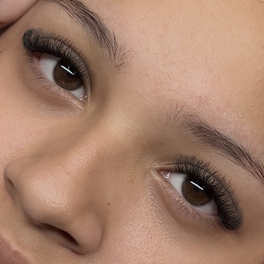 A close-up of a womans eye, showing off her new hybird lash extensions.