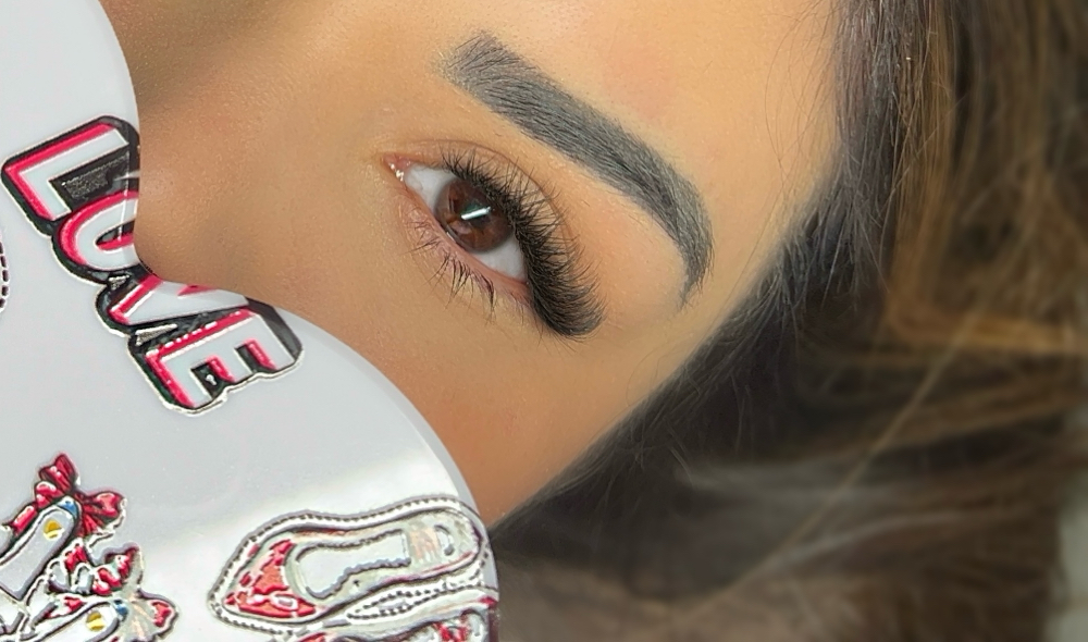 A close-up of a womans eye, showing off her new lash extensions.