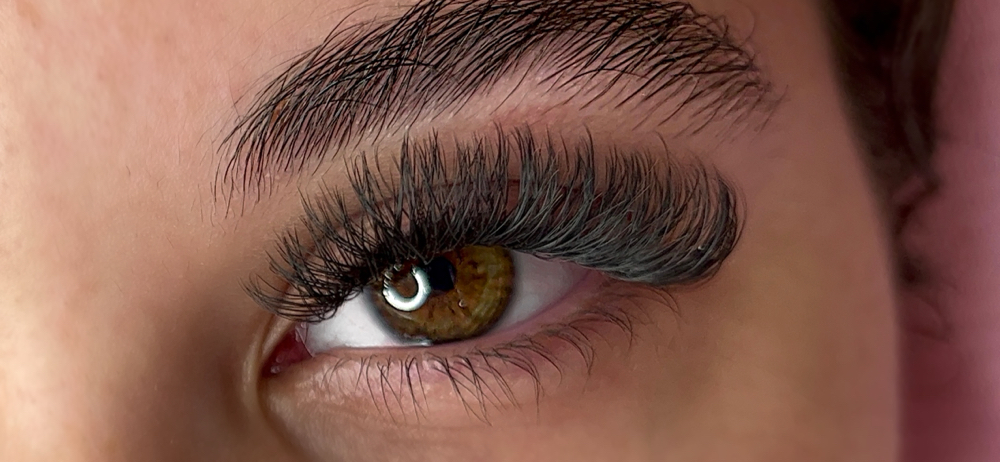 A close-up of a womans eye, showing off her new y-lash extensions.