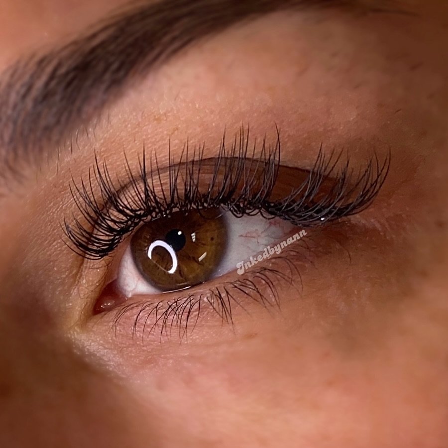 A photo of a woman's eye up close, showing off her new lash extensions.