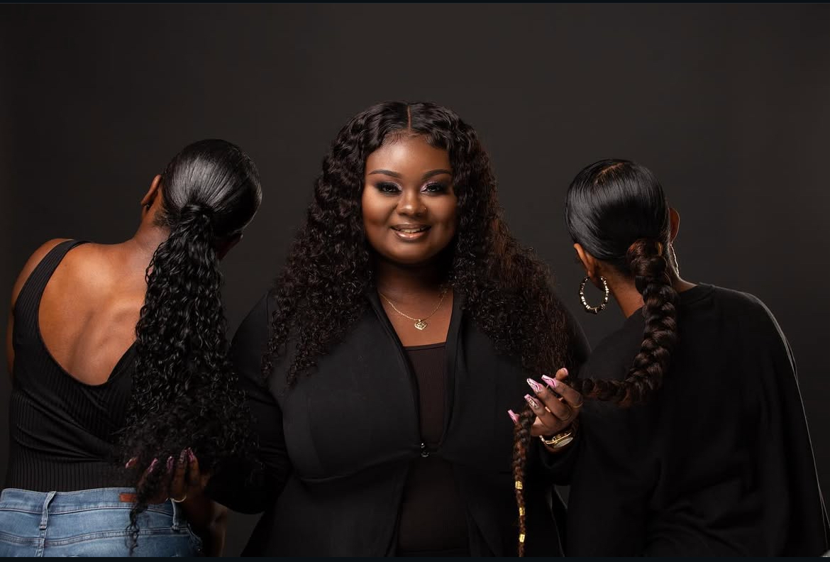 Owner of lolobeautyblvd posing with her clients, who are facing backwards, showing off their new hair-do's.