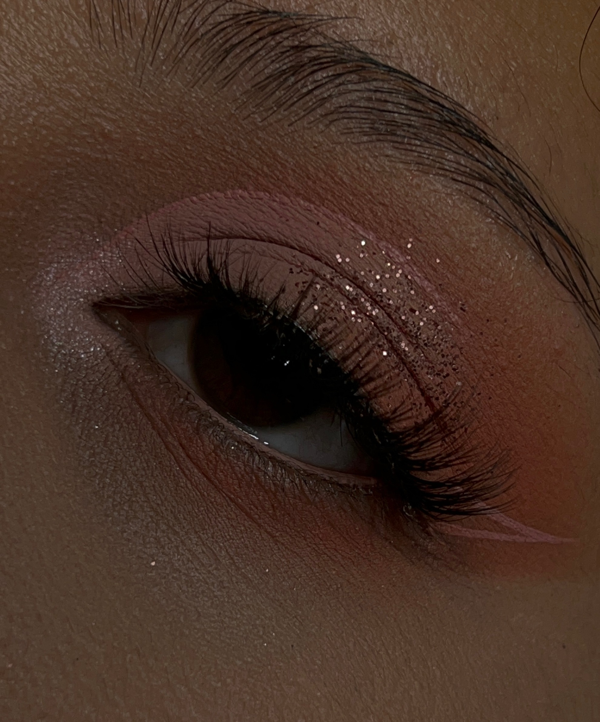 A woman posing, showing off her quince/prom/grad glam makeup.