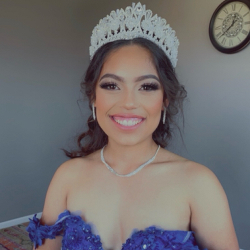 A woman posing as she shows off her newly done Quince makeup.